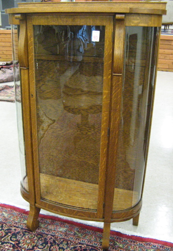 Appraisal: AN ANTIQUE OAK AND CURVED GLASS CHINA DISPLAY CABINET American