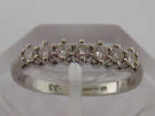 Appraisal: A platinum and diamond half eternity ring the seven brilliants