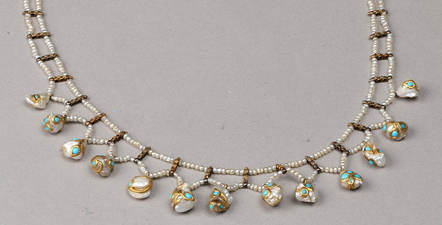 Appraisal: A DOUBLE ROW SEED PEARL NECKLACE with suspended baroque pearls