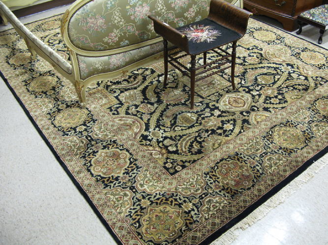 Appraisal: HAND KNOTTED ORIENTAL CARPET Indo-Persian multiple geometric medallions and leafy