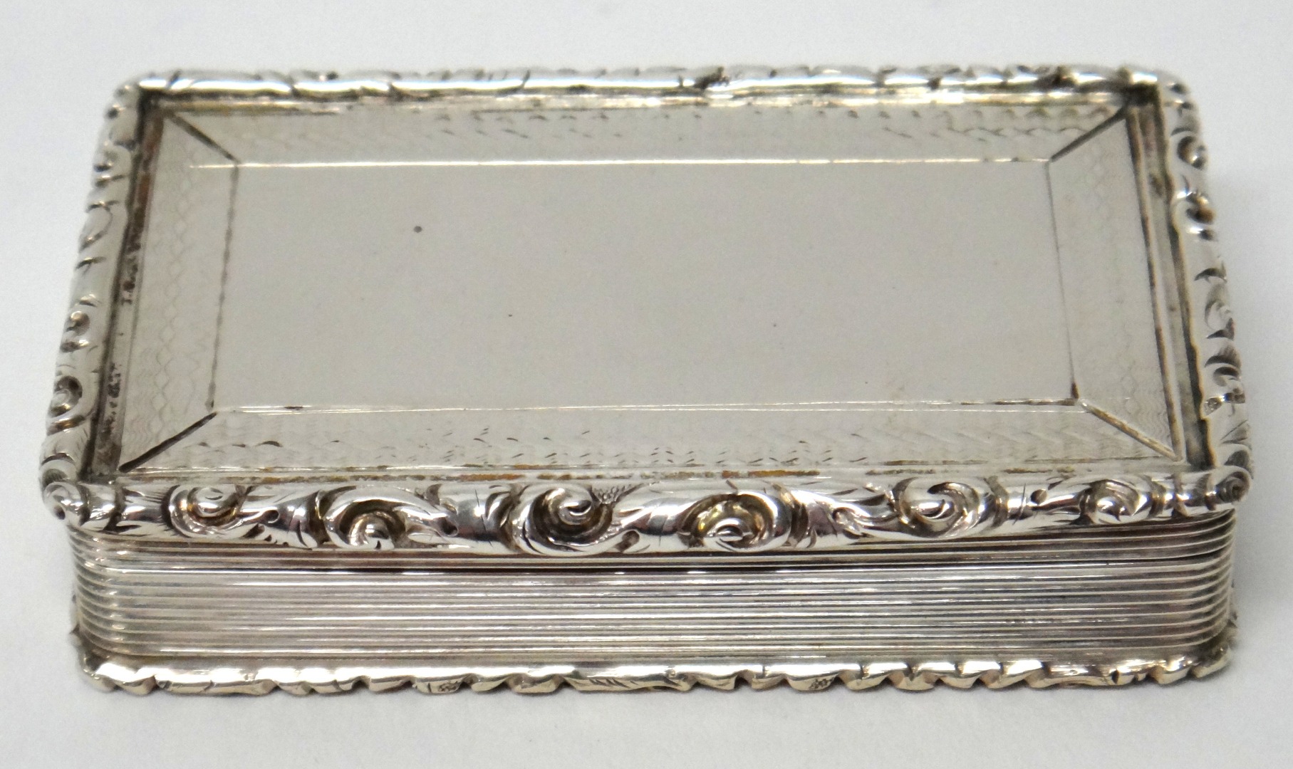 Appraisal: A Victorian silver rectangular snuff box decorated to the borders