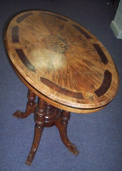 Appraisal: A Victorian walnut and inlaid table the oval top with