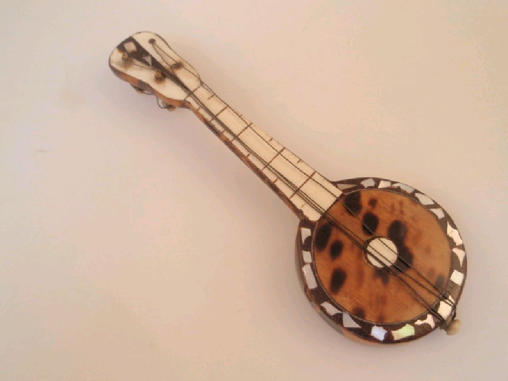 Appraisal: A miniature tortoiseshell covered model of a banjo