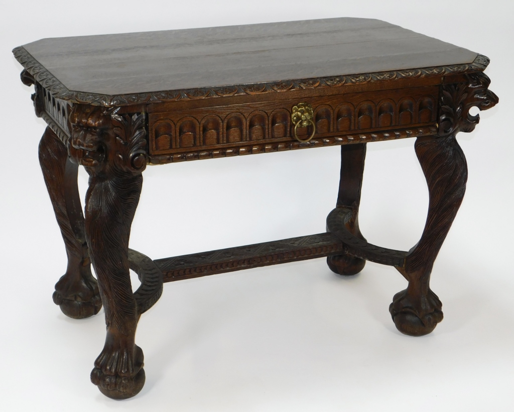 Appraisal: LIONS HEAD OAK LIBRARY TABLE England th CenturyRectangular top supported