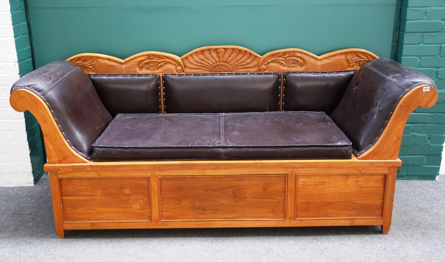 Appraisal: A Biedermeier design walnut framed sofa with carved crest rail