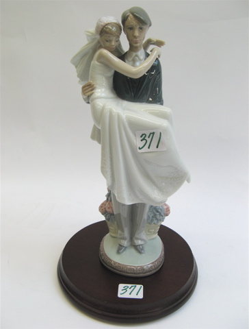 Appraisal: SPANISH LLADRO GLAZED PORCELAIN FIGURAL GROUP of a groom holding