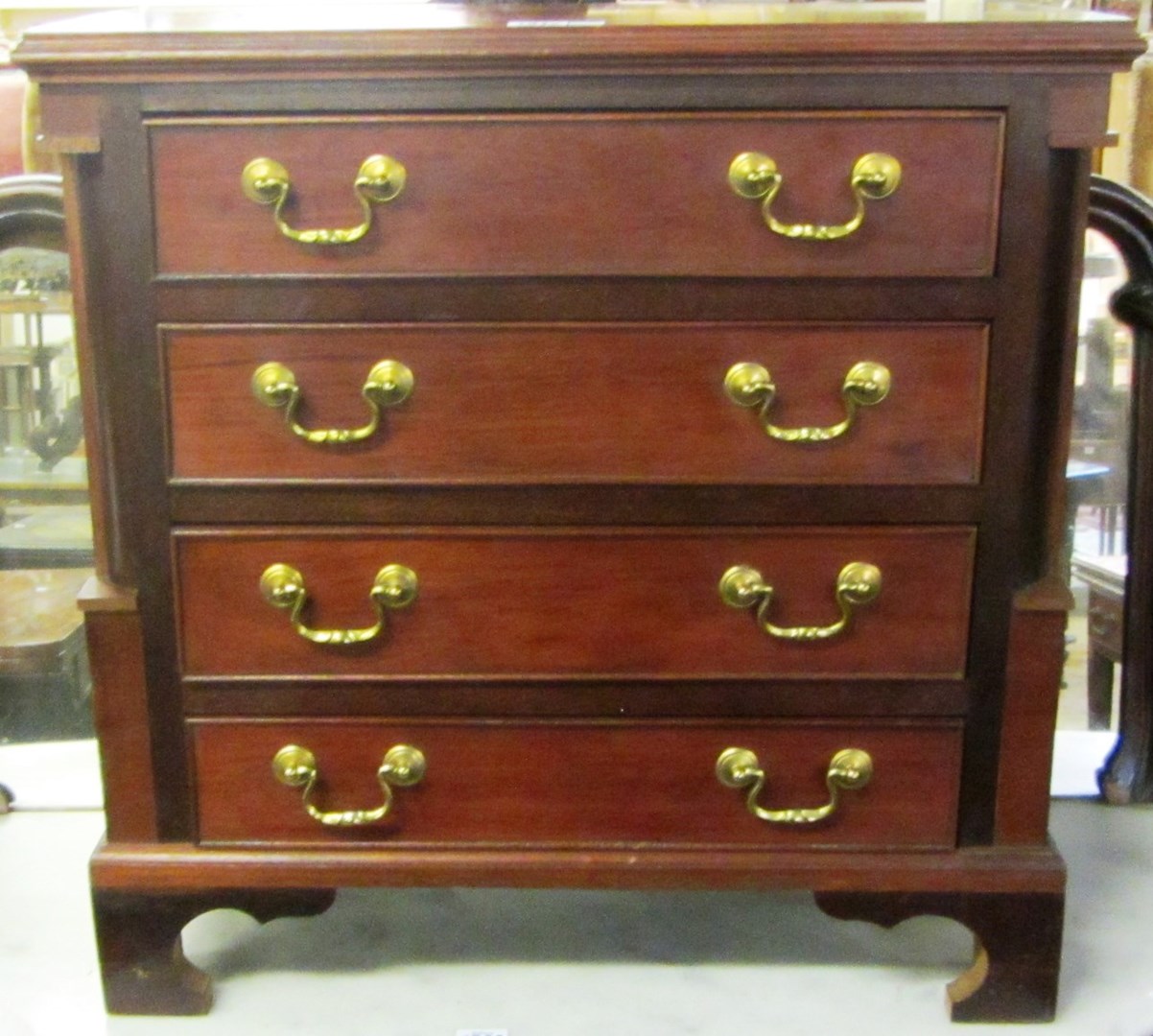 Appraisal: A th century miniature mahogany chest of four long graduated