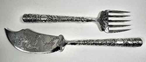 Appraisal: A pair of Chinese silvery metal fish servers the blades