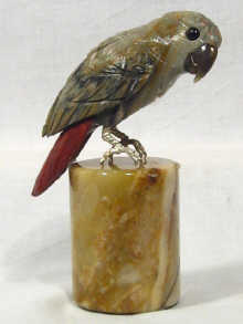 Appraisal: A parrot carved in various coloured stones standing on an