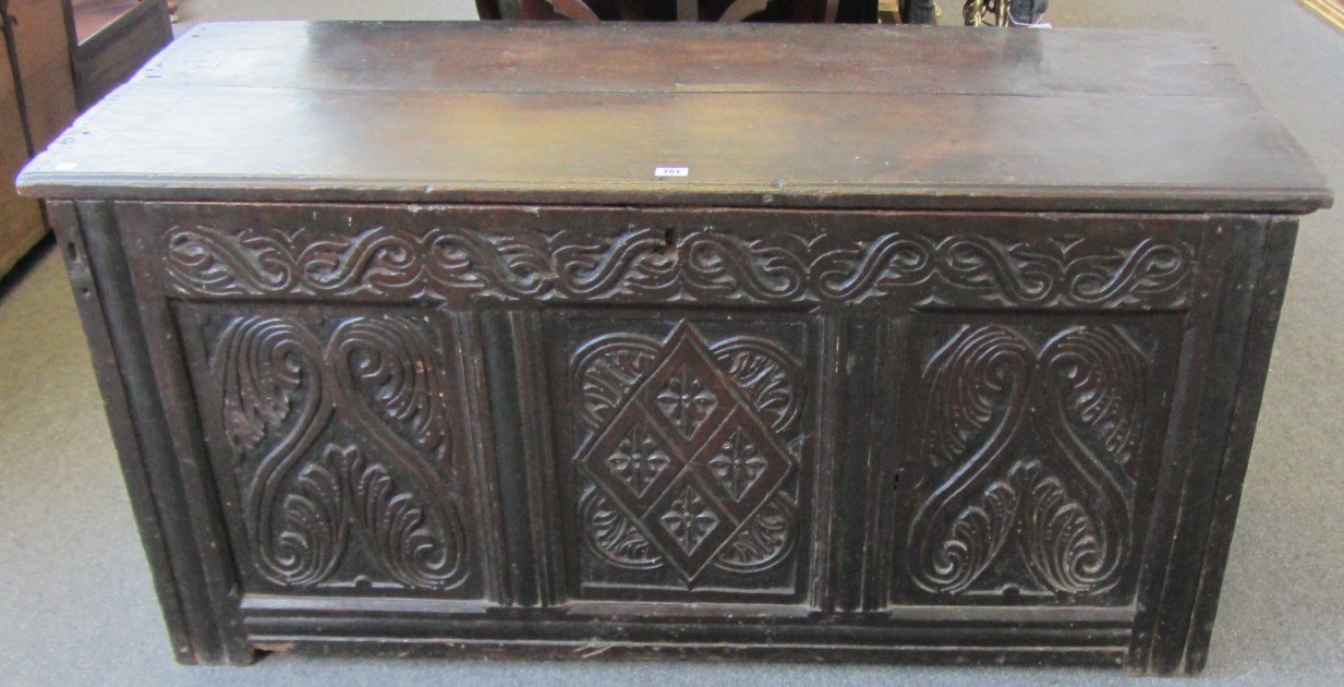 Appraisal: An th century oak coffer the plank top over carved