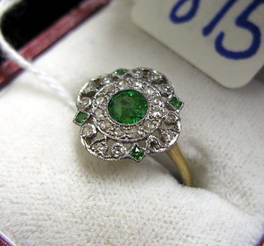 Appraisal: GREEN TSAVORITE GARNET DIAMOND AND EIGHTEEN KARAT GOLD RING centering