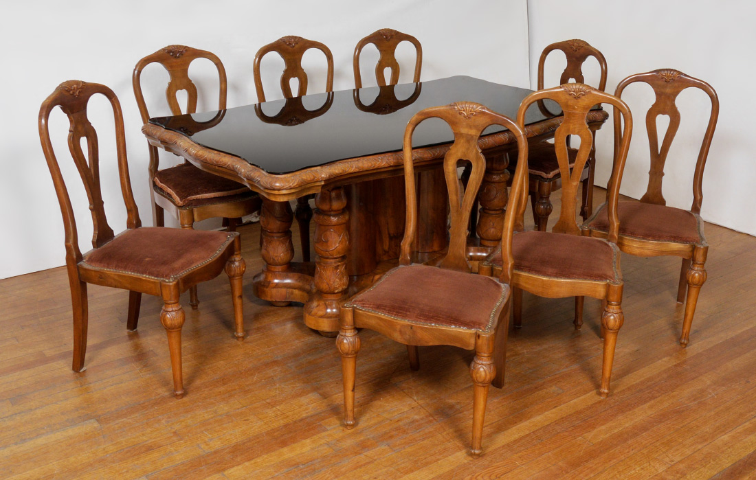 Appraisal: FRENCH WALNUT DINING TABLE CHAIRS Black glass for shaped top