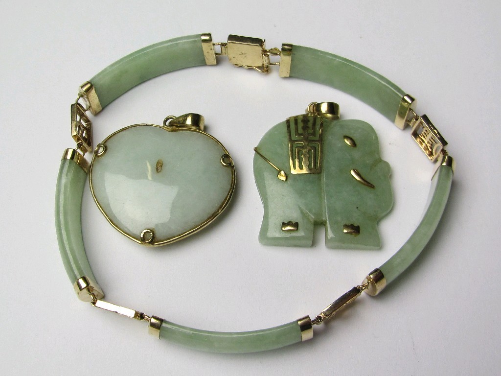 Appraisal: Three ct gold mounted Chinese jade pieces to include heart