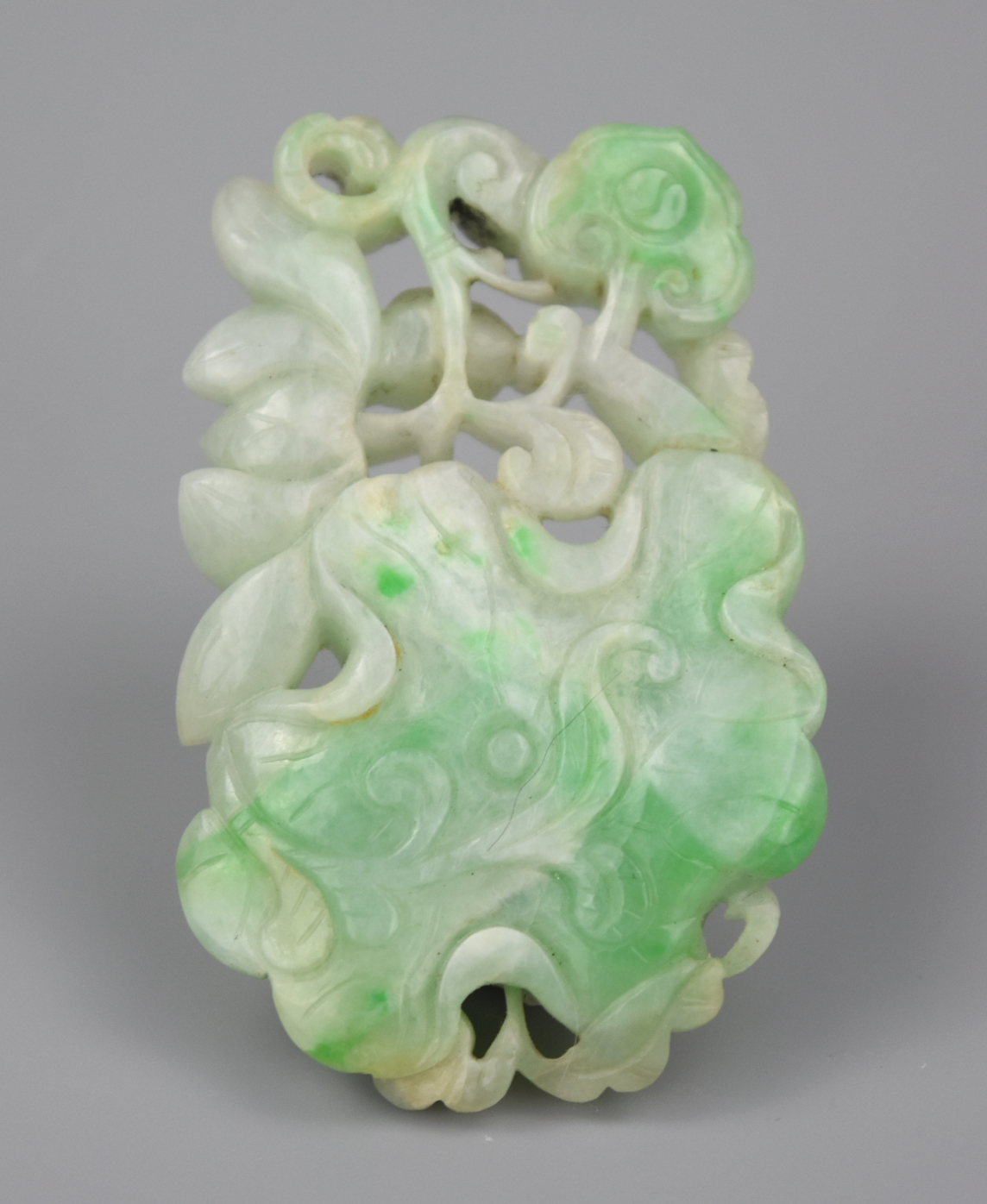 Appraisal: A CHINESE CARVED JADEITE PENDANT W LOTUS QING D An