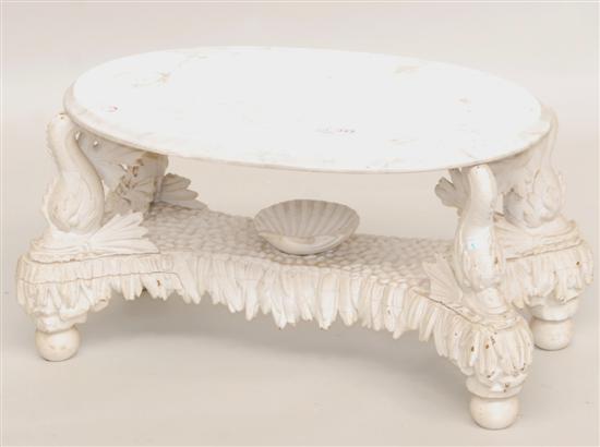 Appraisal: REGENCY-STYLE MARBLE TOP LOW TABLE dolphin supports over carved base