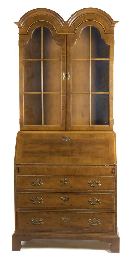 Appraisal: A Georgian Style Double Domed Secretary Bookcase having two glazed