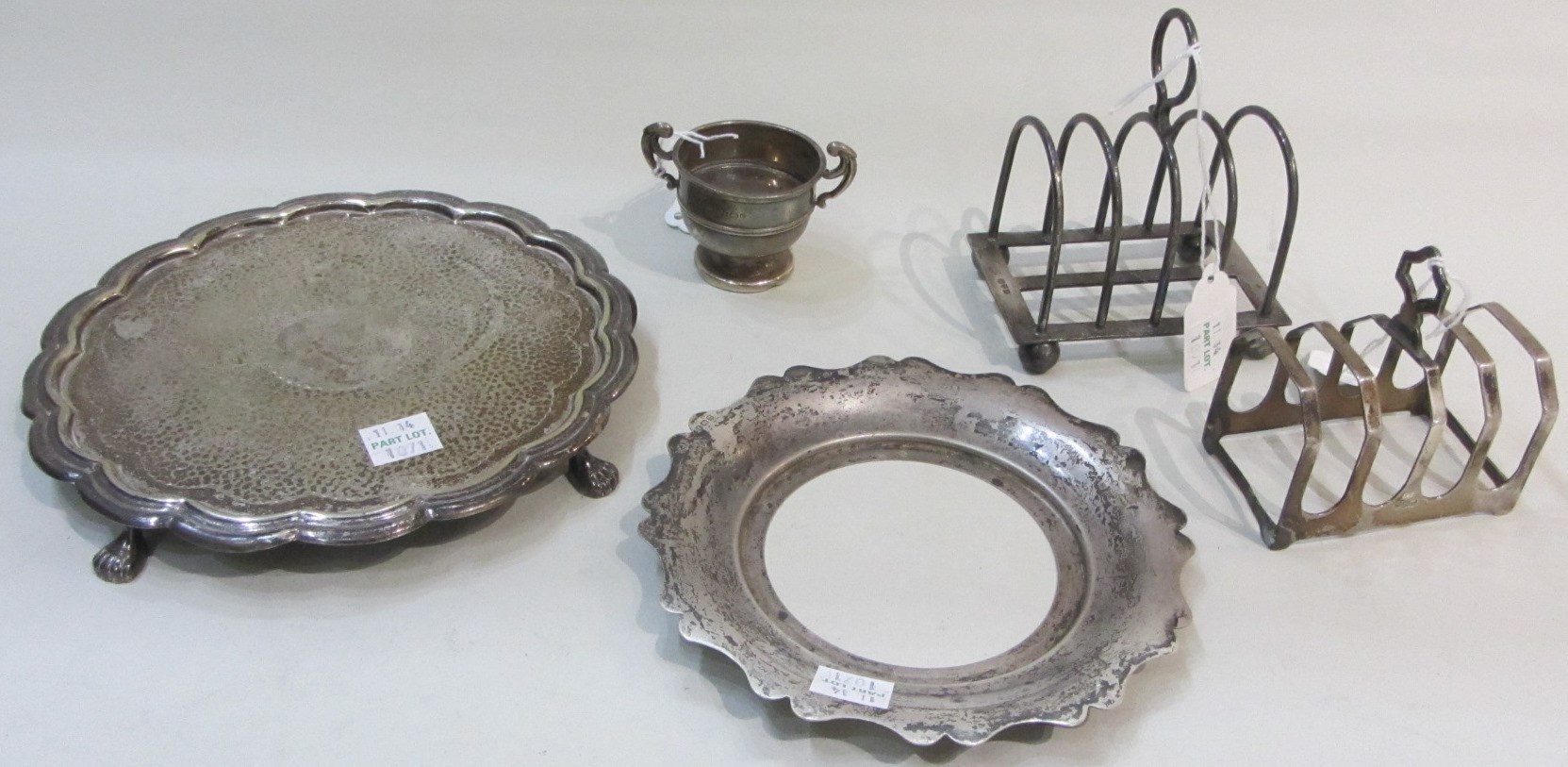 Appraisal: Silver comprising a five bar toast rack raised on spherical