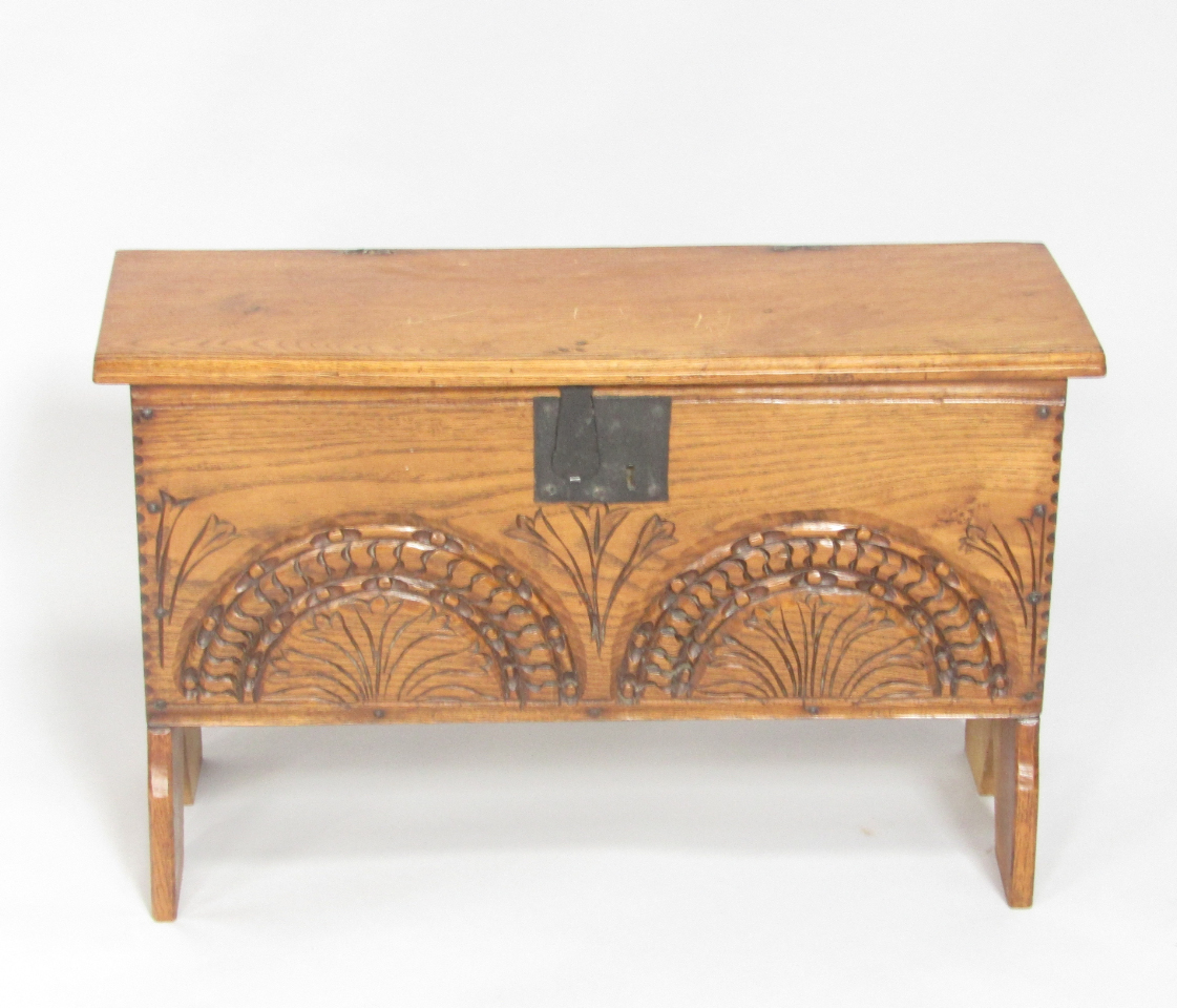 Appraisal: A thC style oak short sword chest with a floral