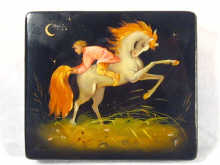 Appraisal: A signed Russian lacquer box depicting a boy sitting backwards