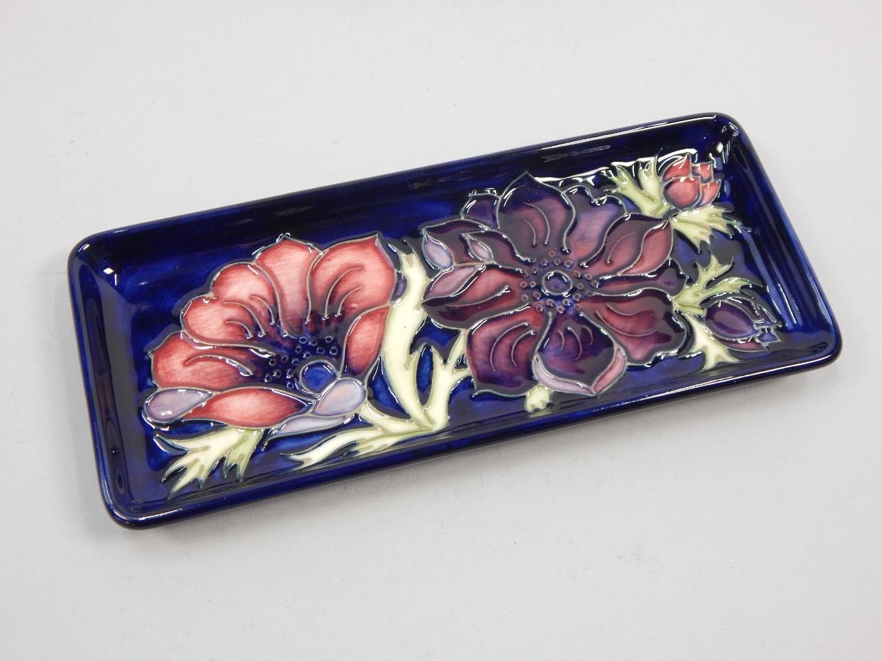 Appraisal: A Moorcroft Anemone pattern rectangular tray on a blue ground