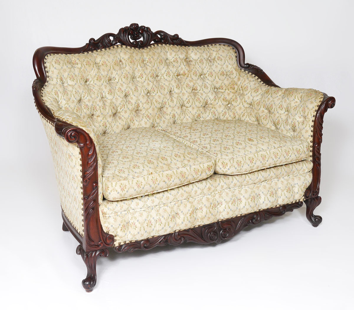 Appraisal: DIMINUTIVE VICTORIAN CARVED SOFA Frame carved all over with pierced