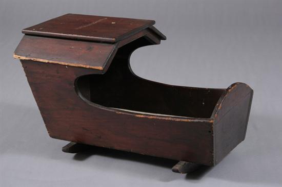 Appraisal: AMERICAN WALNUT-FINISH PINE WOODEN HOODED DOLL CRADLE th century With