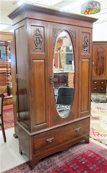 Appraisal: LATE VICTORIAN CARVED WARDROBE English c centering a single door