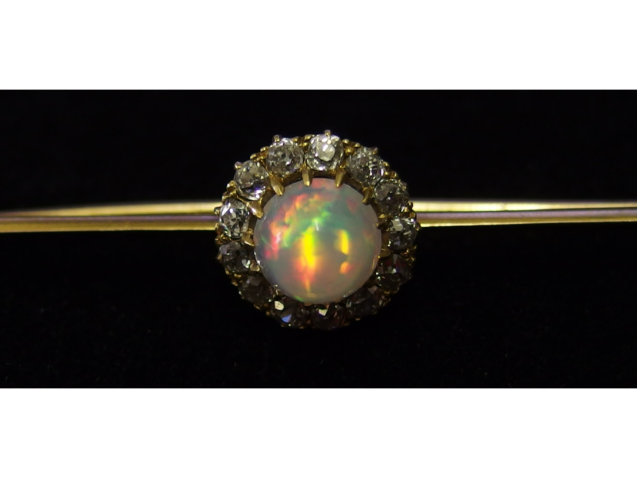 Appraisal: A fiery high cabouchon opal and old cut diamond bar