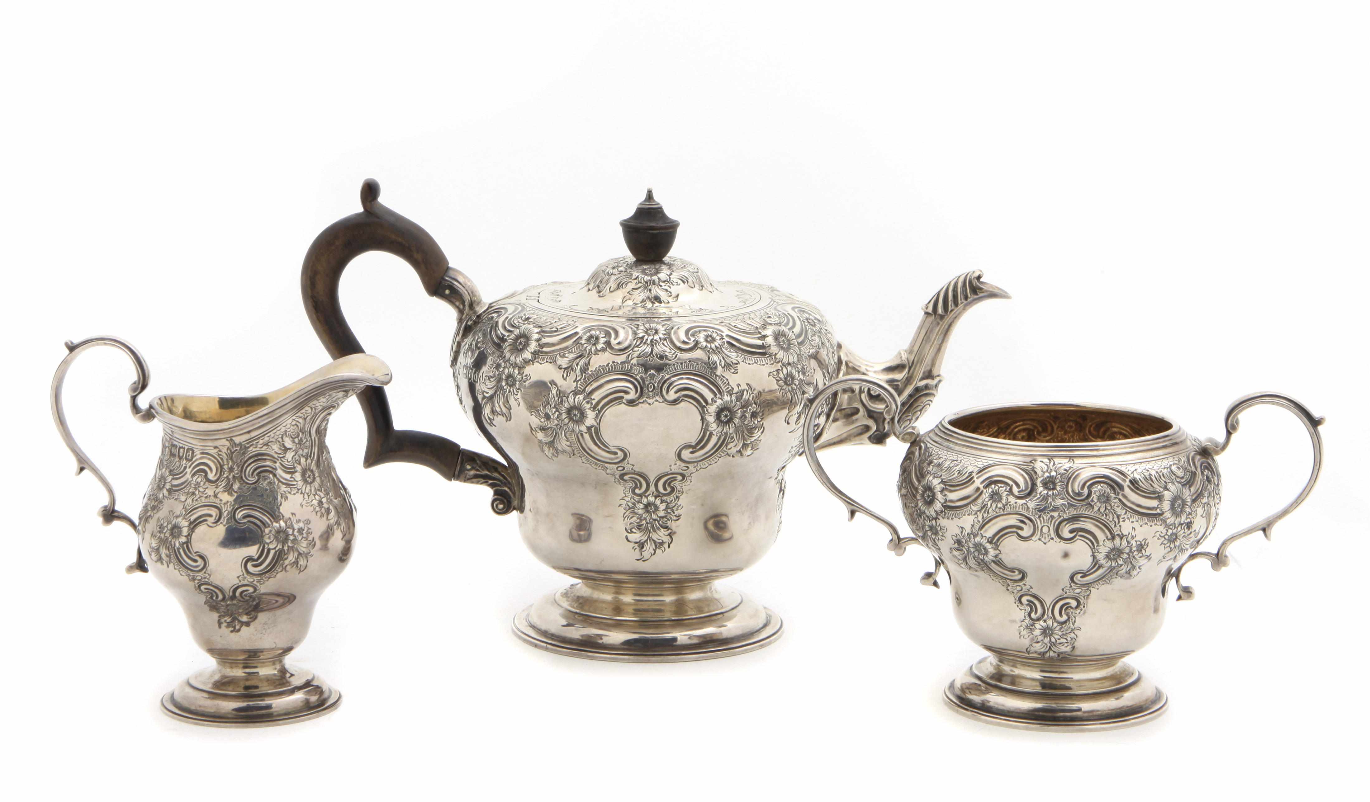 Appraisal: A Victorian sterling silver floral repousse decorated three piece 'tete