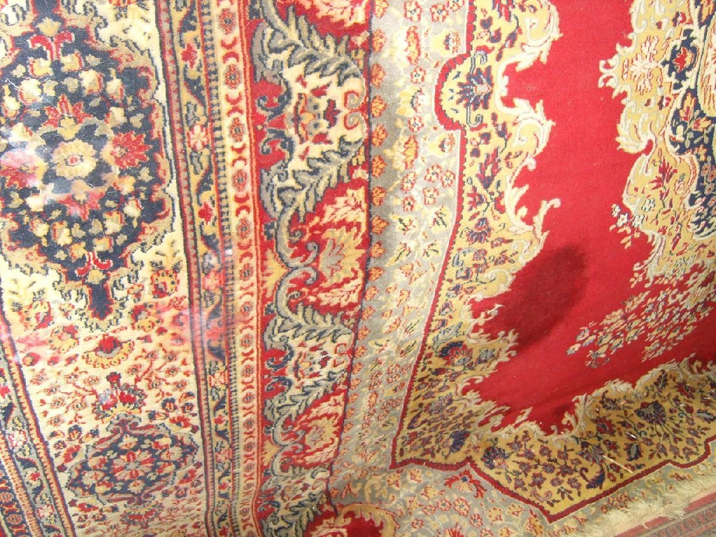 Appraisal: A red ground wool carpet in the eastern style with