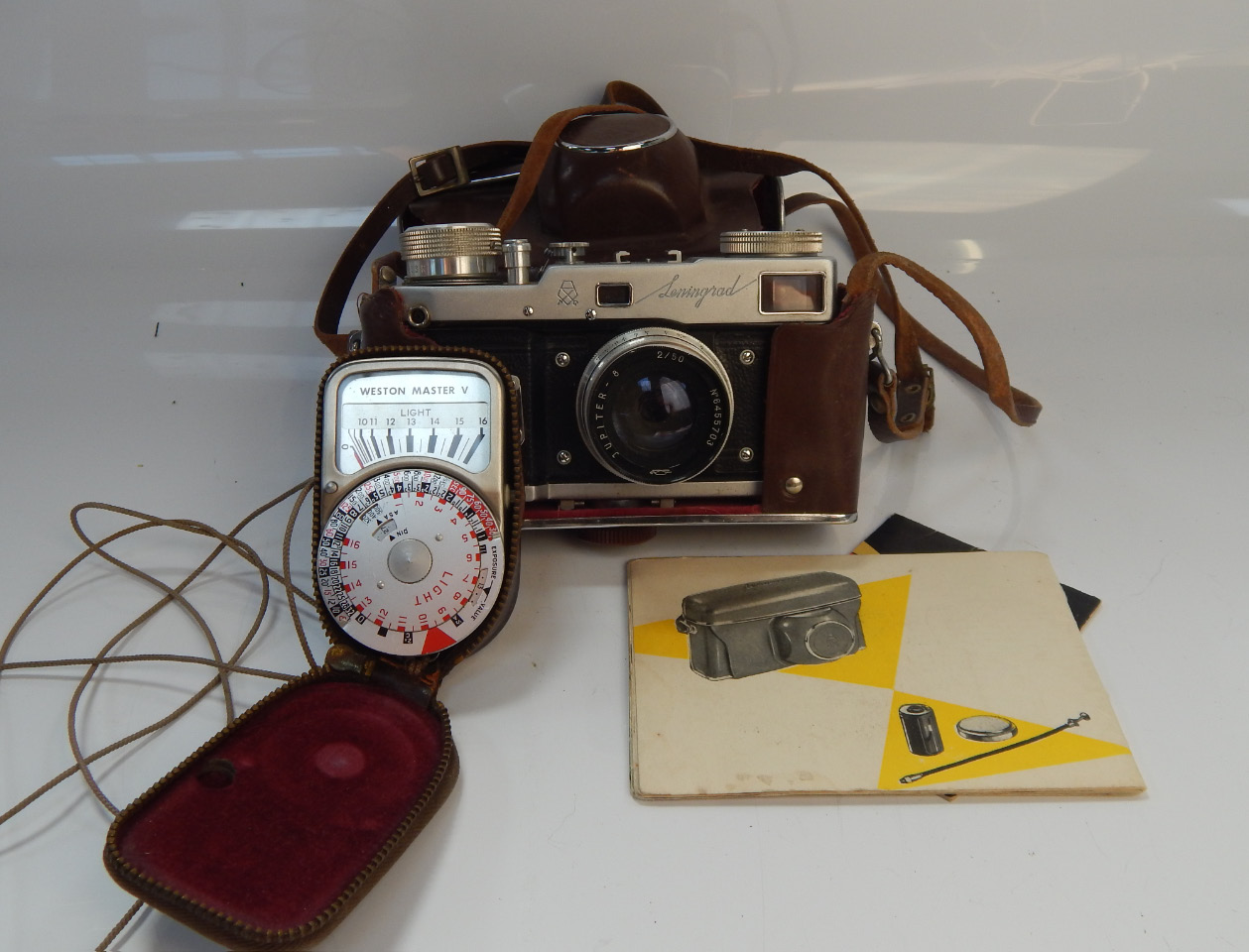 Appraisal: A Leningrad SLR camera with assorted paperwork and a light