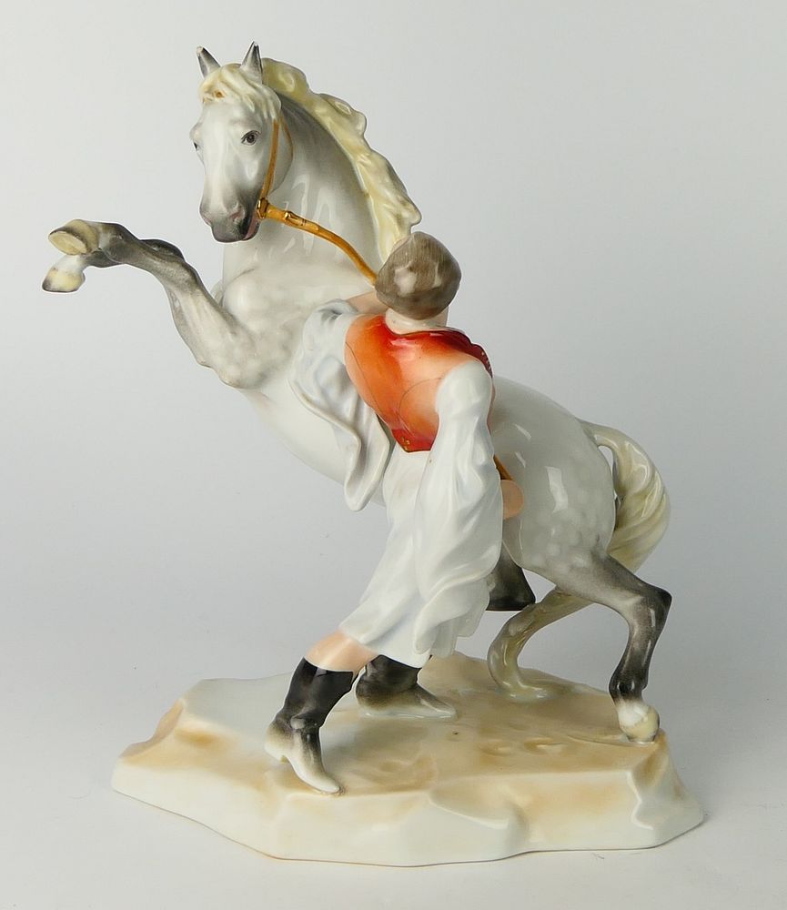 Appraisal: HERAND REARING HORSE WITH TRAINER Herend porcelain grouping rearing horse