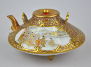 Appraisal: Japanese Satsuma compressed disk shape small teapot decorated with shaped