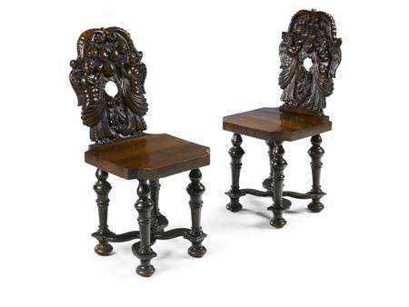 Appraisal: A pair of th century carved walnut hall chairs In