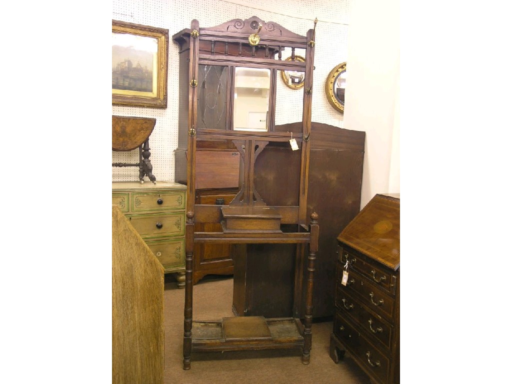 Appraisal: An Edwardian oak hall stand fitted with brass hooks bevelled