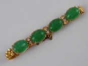 Appraisal: A yellow metal tests carat gold cabochon jade and diamond