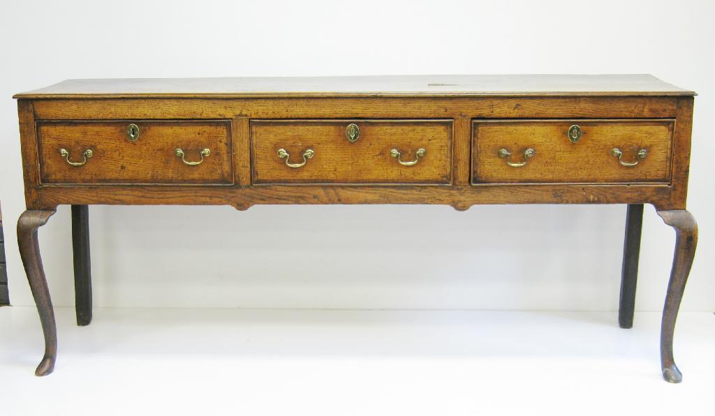 Appraisal: An antique oak Dresser Base fitted three drawers cross-banded with