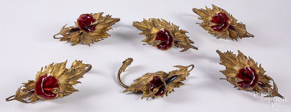 Appraisal: Six gilt metal and ruby glass curtain tiebacks Set of