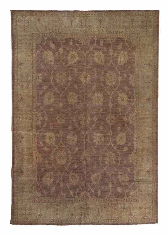 Appraisal: A Pakistani Wool Rug having allover stylized foliate decoration on