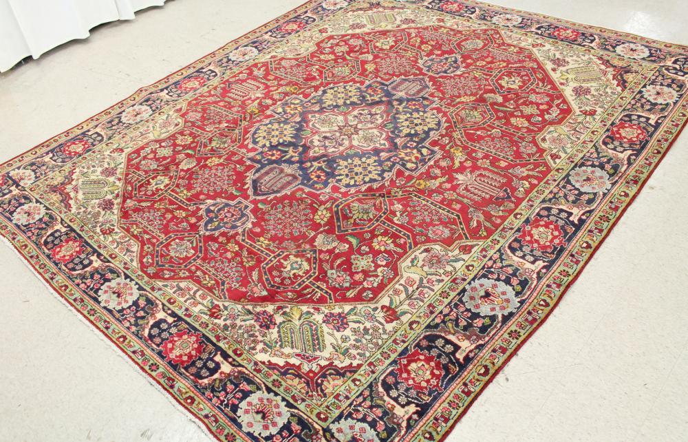 Appraisal: HAND KNOTTED PERSIAN CARPET stylized floral and central floral medallion