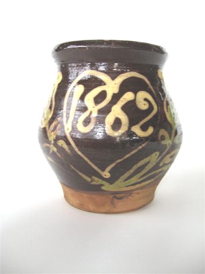 Appraisal: Slip-decorated and dated redware jug With ivory and green tulip