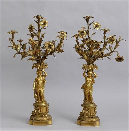 Appraisal: PAIR OF LOUIS XV-STYLE GILT-BRONZE FIGURAL SIX-LIGHT CANDELABRA Each modeled