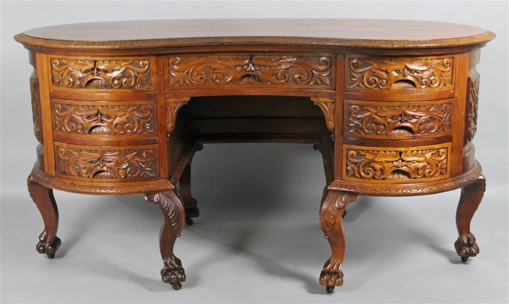 Appraisal: INDONESIAN CARVED WOOD KIDNEY-SHAPED DESK the kidney shaped top above