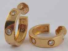 Appraisal: A pair of Swiss hallmarked carat gold and diamond Cartier