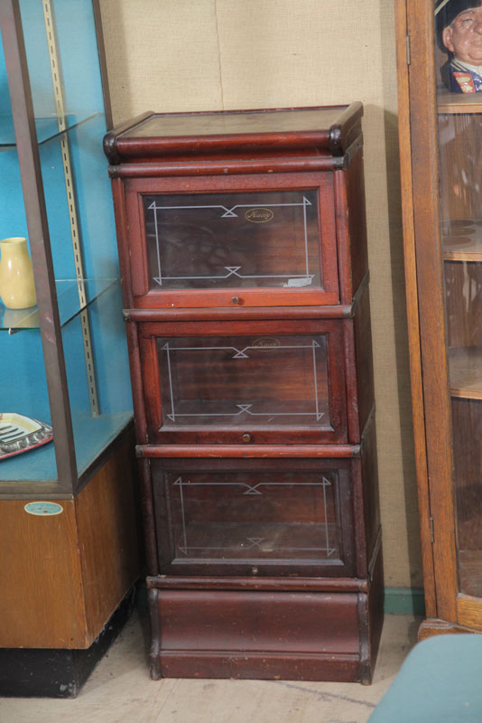 Appraisal: DIMINUTIVE STACKED BOOKCASE Mahogany and consisting of three stacks glazed