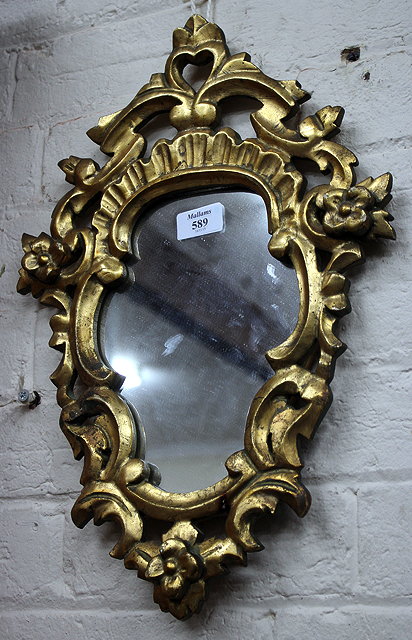 Appraisal: A SMALL VENETIAN STYLE GILT FRAMED CARVED WOOD MIRROR with