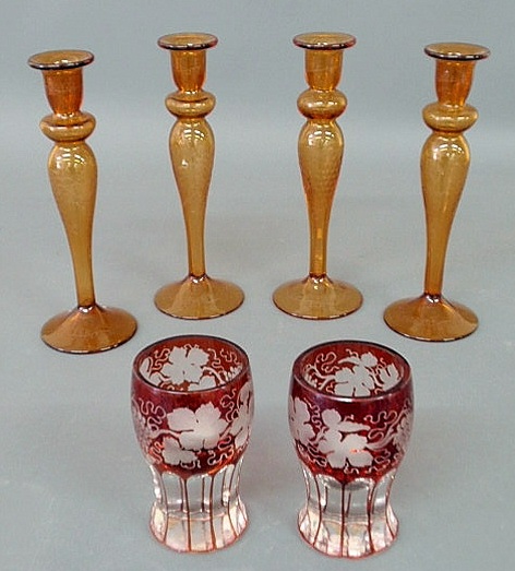 Appraisal: Four amber glass candlesticks and two cranberry-cut-to-clear Bohemia glass tumblers