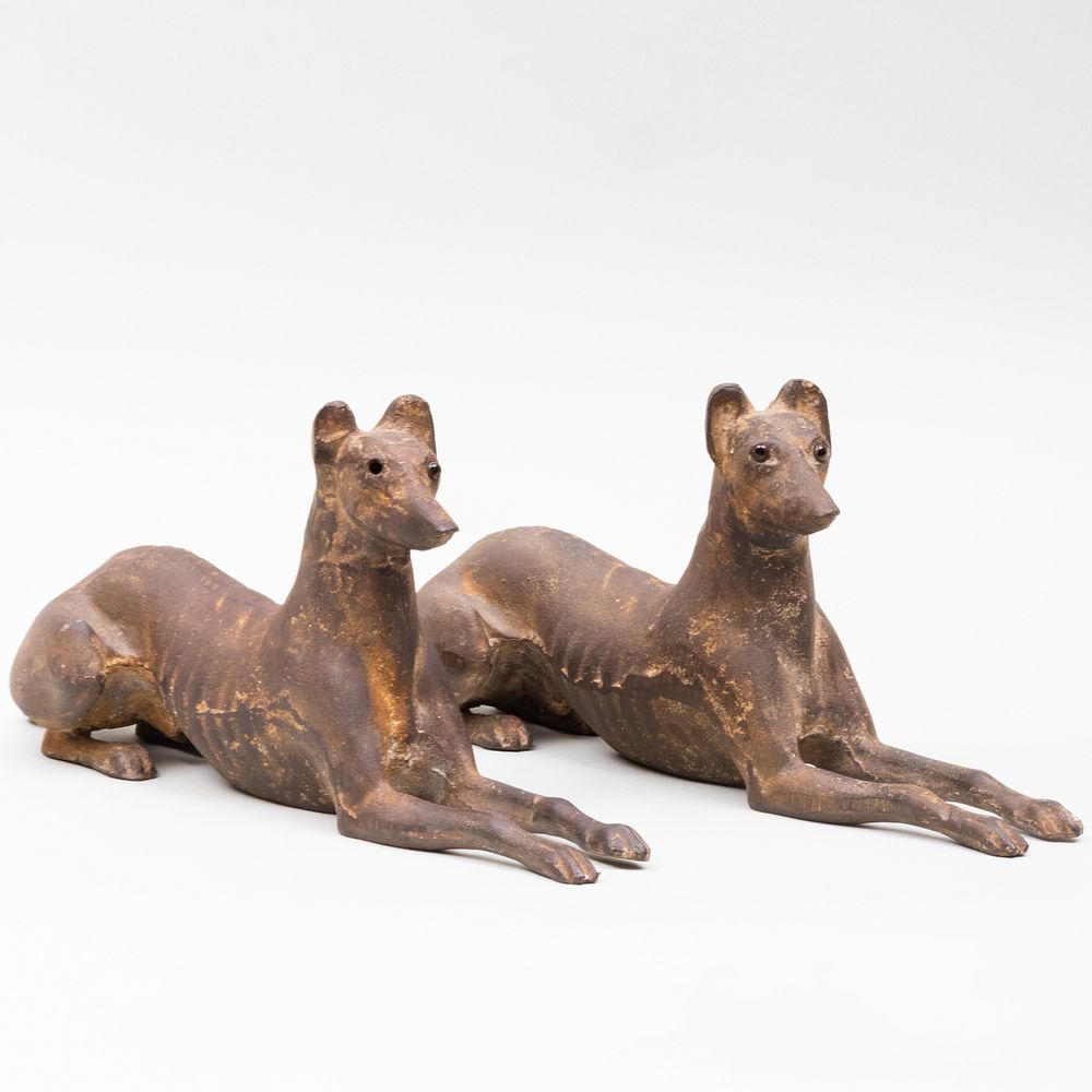 Appraisal: Pair of Cast-Iron Reclining Whippets x in Condition One with