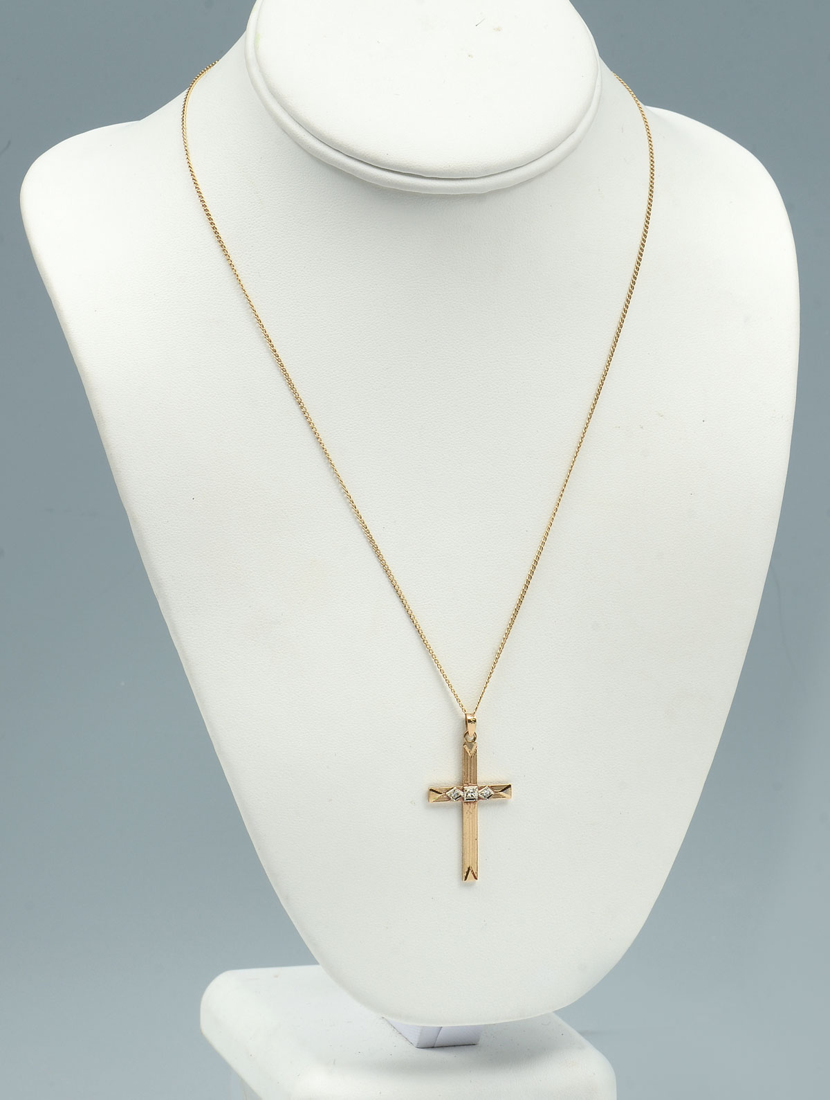 Appraisal: K DIAMOND STYLIZED CROSS CHAIN Art-deco stylized yellow gold cross