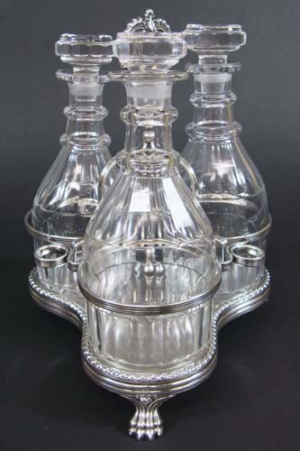 Appraisal: SILVER PLATED -BOTTLE TANTALUS having an ornate stand with floral